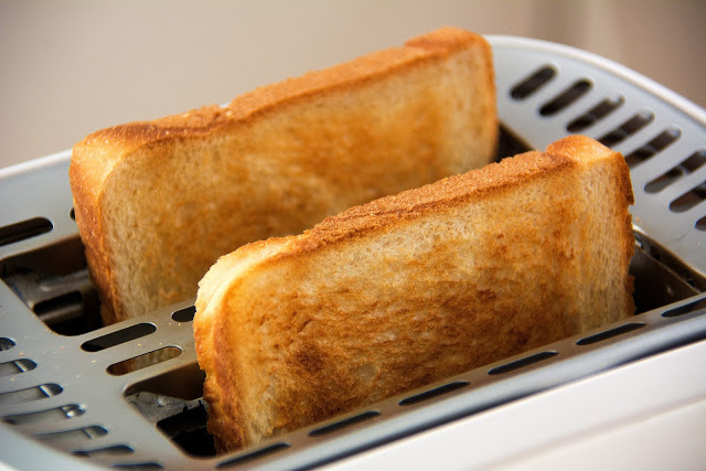 Picture of two slices of toast in a toaster